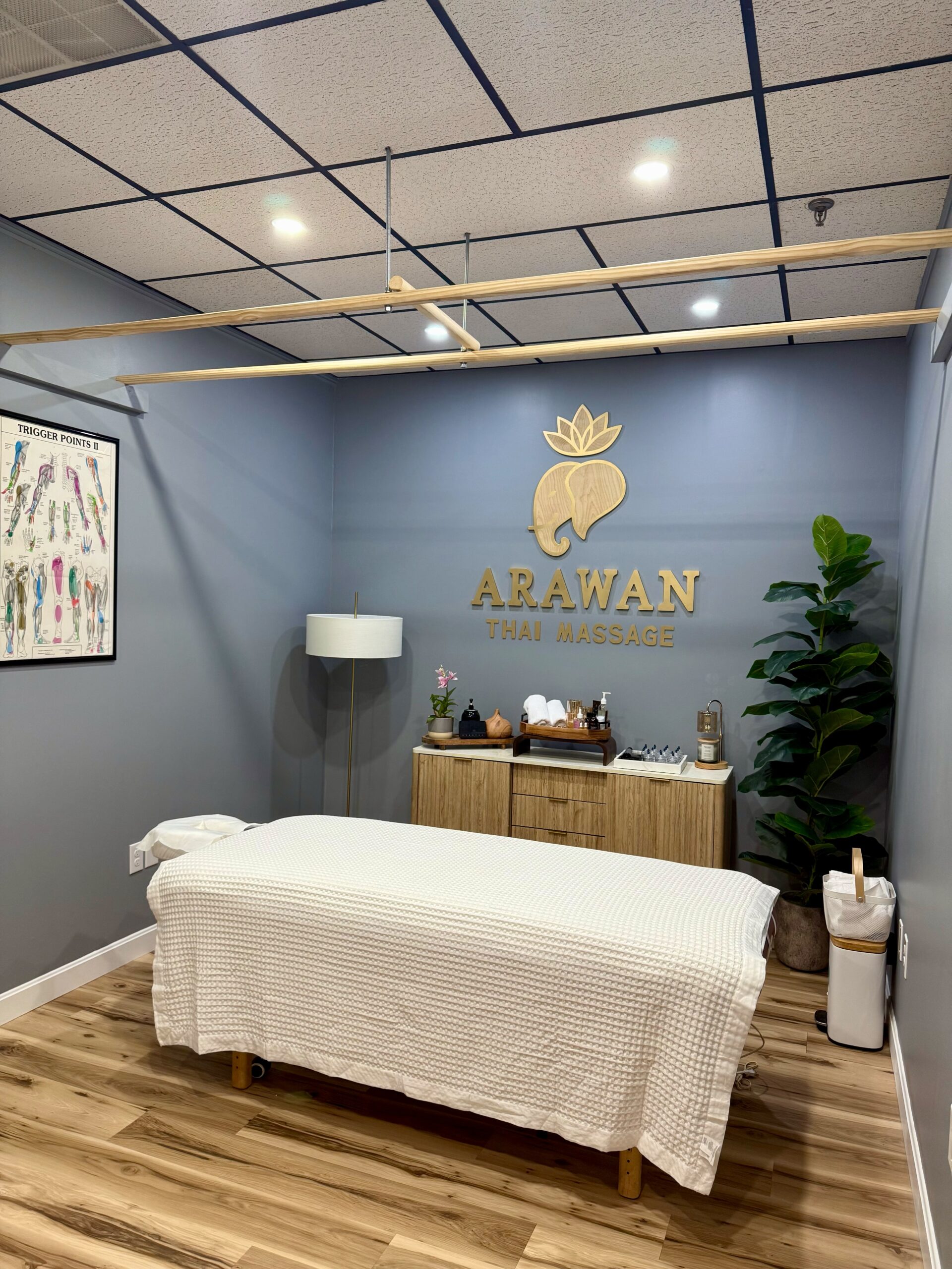 Massage studio with white massage bed.